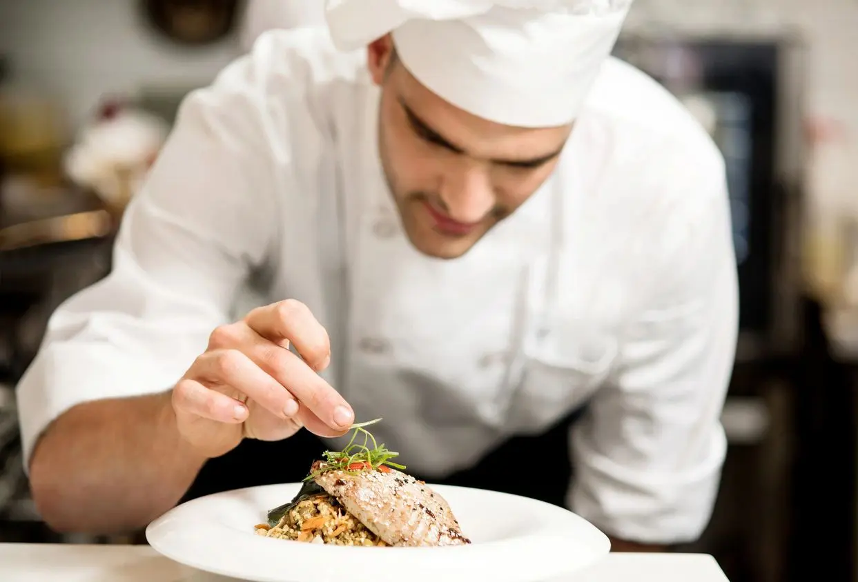 A Chef Working on Adding Rosemary to a Slice