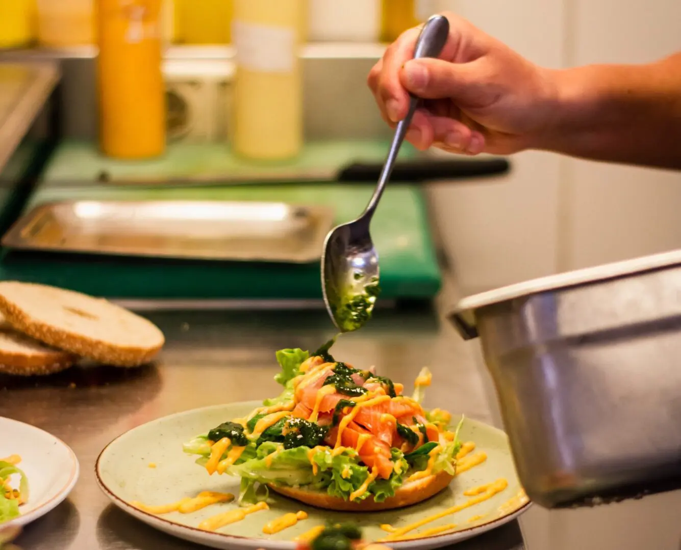 A Person Adding Salad to a Slice of Bread